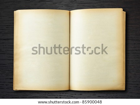 stock photo old book open on dark wood background
