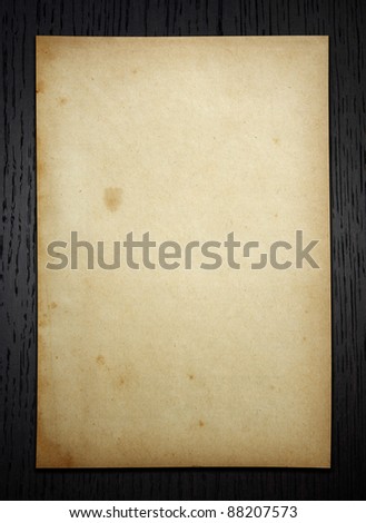 Old paper on dark wood  background with clipping path