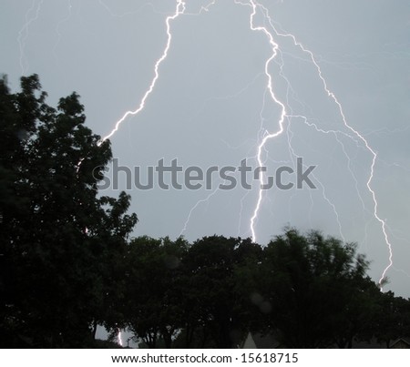 Daytime lightning strike hitting ground
