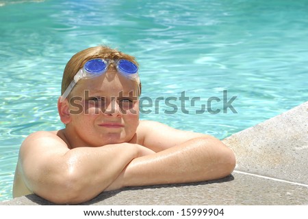 stock photo Teen preteen boy with goggles leaning on the side of a 