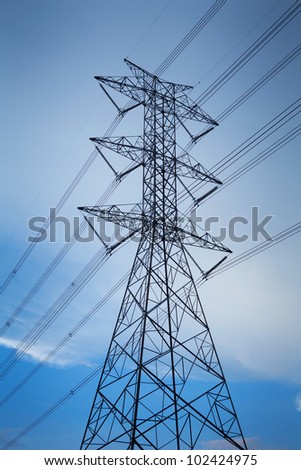 Electric power station in the field on blue sky