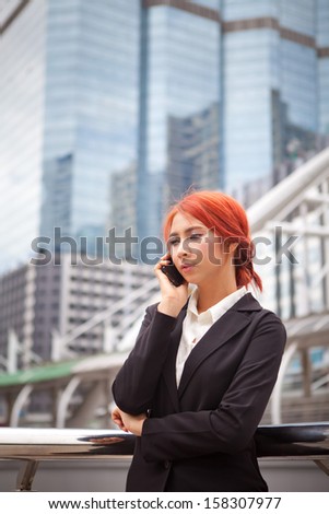 Young business asian woman calling on the phone at modern city
