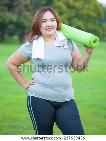 Pretty fat asian woman going to work out with her yoga mat