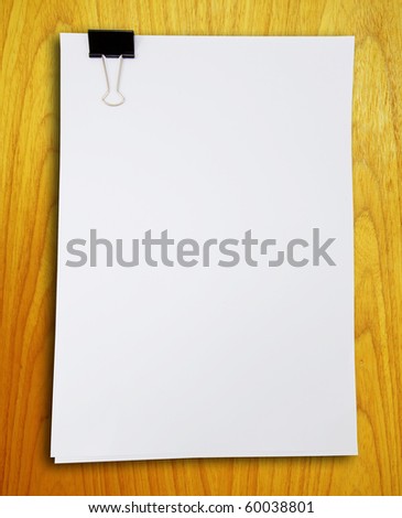 Binder clip and stack of paper on the wood pattern