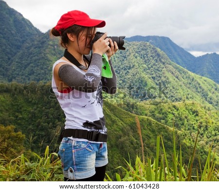 pretty female photographer on the mountain