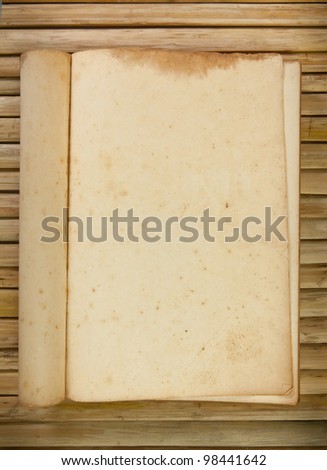 Open old book on the wood background