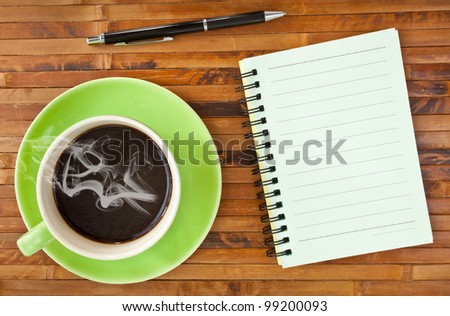 green cup coffee and note paper on wood background