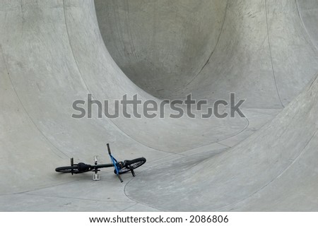 bmx on the ground in skate bowl