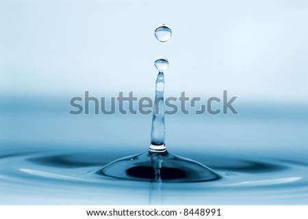 isolated water drop with rippling water and tower of water