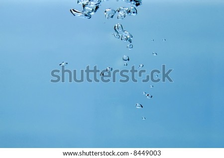 isolated air-bubbles rising in the water, isolated over blue