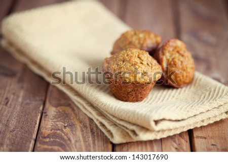 Mini Muffins on Cloth Napkin and Wood Background