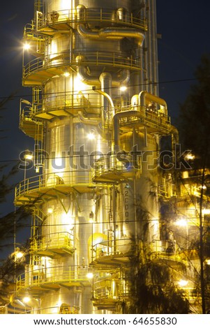 Petroleum refinery distiller column at night