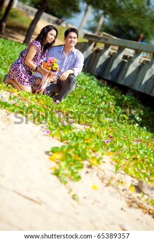 stock photo Pre wedding bride and groom sit down at the beach