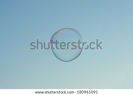 Large rainbow bubble flies in the sky