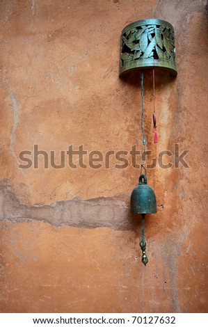 Antique rusty bell on the vintage wall