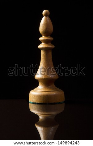 Chess bishop on black background