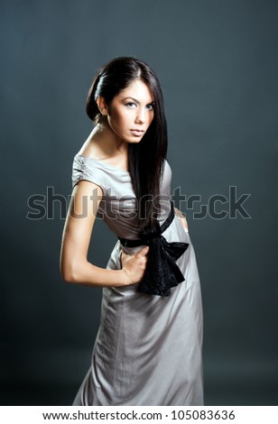 Young girl posing in gray dress