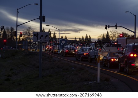 Line of Automobiles Stopped At Light Twilight