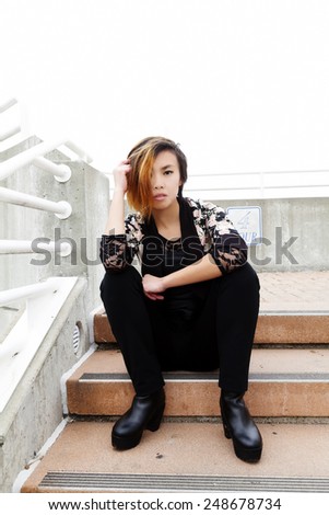 Asian American Woman Sitting On Steps Pants