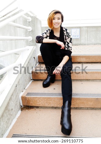 Attractive Asian American Woman Sitting On Steps