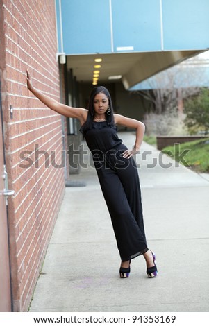 Young Black Woman Pants Suit Standing Wall