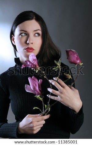 a sad lady with pink flowers looking