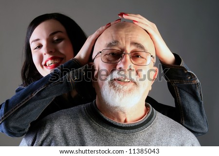 grandpa and granddaughter smiling together