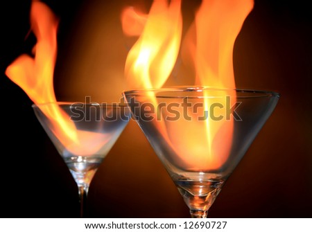 two cocktails with fire on white background