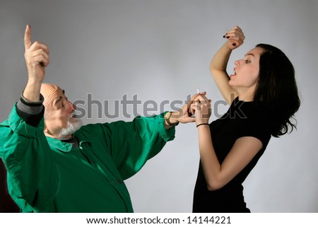 a senior man and young girl are fighting