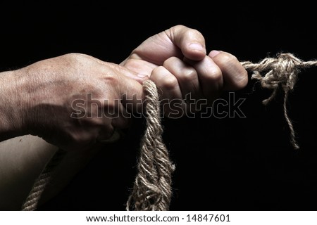 photo of a rope with hand pulling