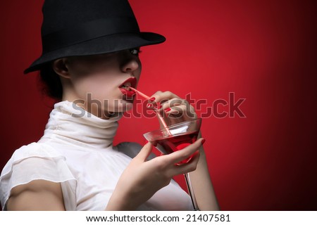 a lady with hat is drinking cocktail
