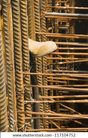 Workers Boot and Steel Supports on Building Site