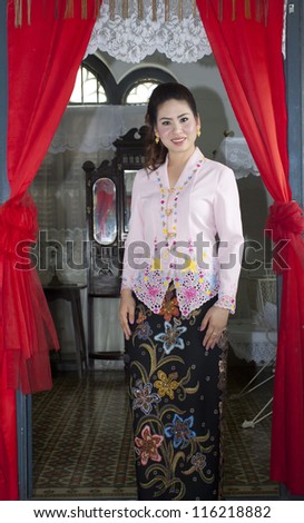portrait of beautiful asian woman smiling with traditional clothing Peranakan dress