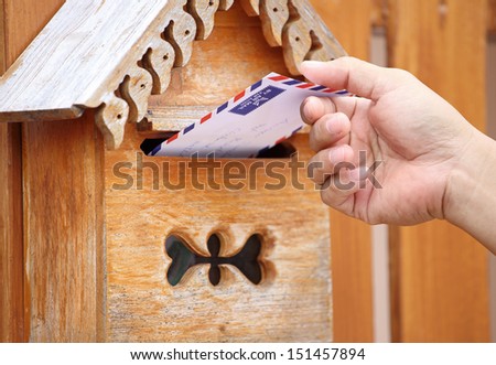 male hand pull mail from mailbox