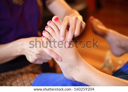 reflexology foot massage, spa foot treatment by wood stick,Thailand