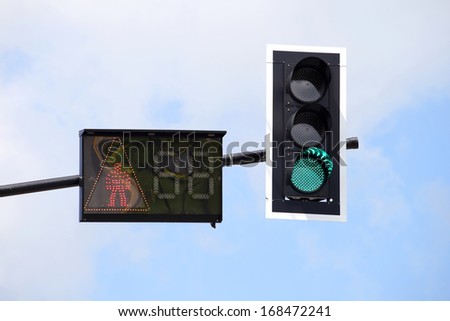 Traffic Light with cross walk light in blue sky