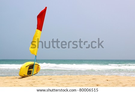 Surf Rescue surfboard and flags on Naiharn beach, Phuket Thailand