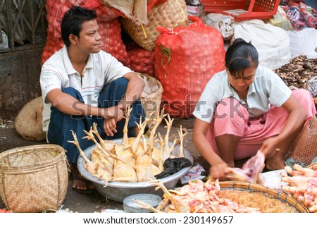 Yangon, Myanmar - 8 January 2010: street seller at the market of Yangon on Myanmar