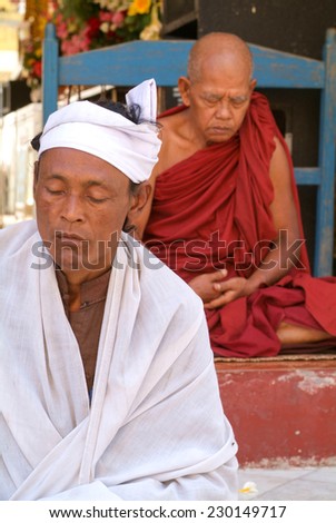 Yangon, Myanmar - 9 January 2010: Monks on meditation at the Sule Paya Pagoda in Yangon on Myanmar