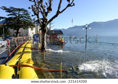 Lugano, Switzerland - 18 November 2014: People of civil Protection pumping water of the inundation of lake Lugano on Switzerland