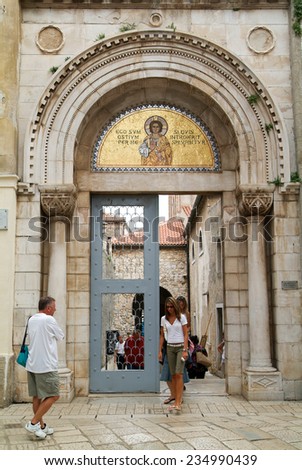 Porec, Croatia - 23 August 2005: People at the entrance door of the Euphrasian Basilica at Porec on Croatia