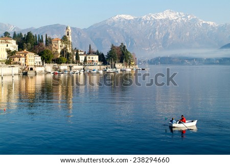 Tremezzo, Italy - 8 January 2005:People on a rowing boat at the coast of lake Como near Tremezzo on Italy