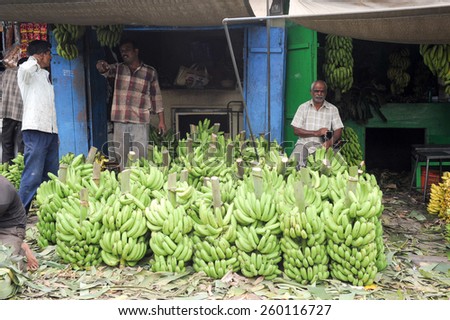 Mysore, India - 24 January 2015:  Indian vendors tend to their banana stall in the Devaraja fruit market at Mysore on India