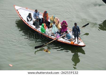 Varanasi, India - 28 January 2015: Indian tourists taking the popular boat tour on the sacred Ganges river in Varanasi, Uttar Pradesh, India