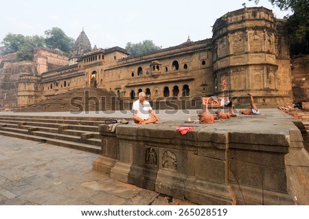 Maheshwar, India - 4 February 2015: People doing yoga and meditation in front of Maheshwar palace on India