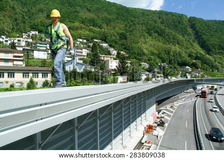 Bissone, Switzerland - 20 May 2010: Workers during the installation of noise barriers on the highway at Bissone on Switzerland