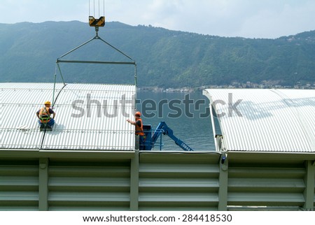 Bissone, Switzerland - 29 April 2010: Workers during the installation of noise barriers on the highway at Bissone on Switzerland