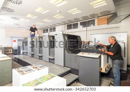 Bern, Switzerland - 19 september 2013: people working at an offset printing machine at Bern on Switzerland