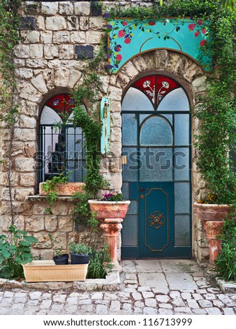 Old house door and window with ivy braid it, Rosh Pinna, Upper Galilee, Israel