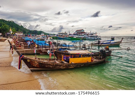 PHI PHI ISLAND, THAILAND- - JULY 24, 2007: fishing boats parking near beach on Phi Phi  island after the workday in gloomy weather
